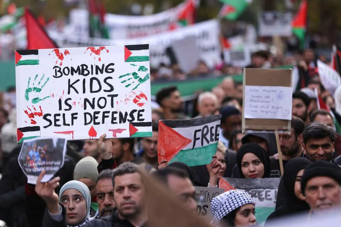 Demonstrators hold placards during a protest in solidarity with Palestinians in Gaza, amid the ongoing conflict between Israel and the Palestinian Islamist group Hamas, in Duesseldorf, Germany, October 21, 2023. REUTERS/Thilo Schmuelgen