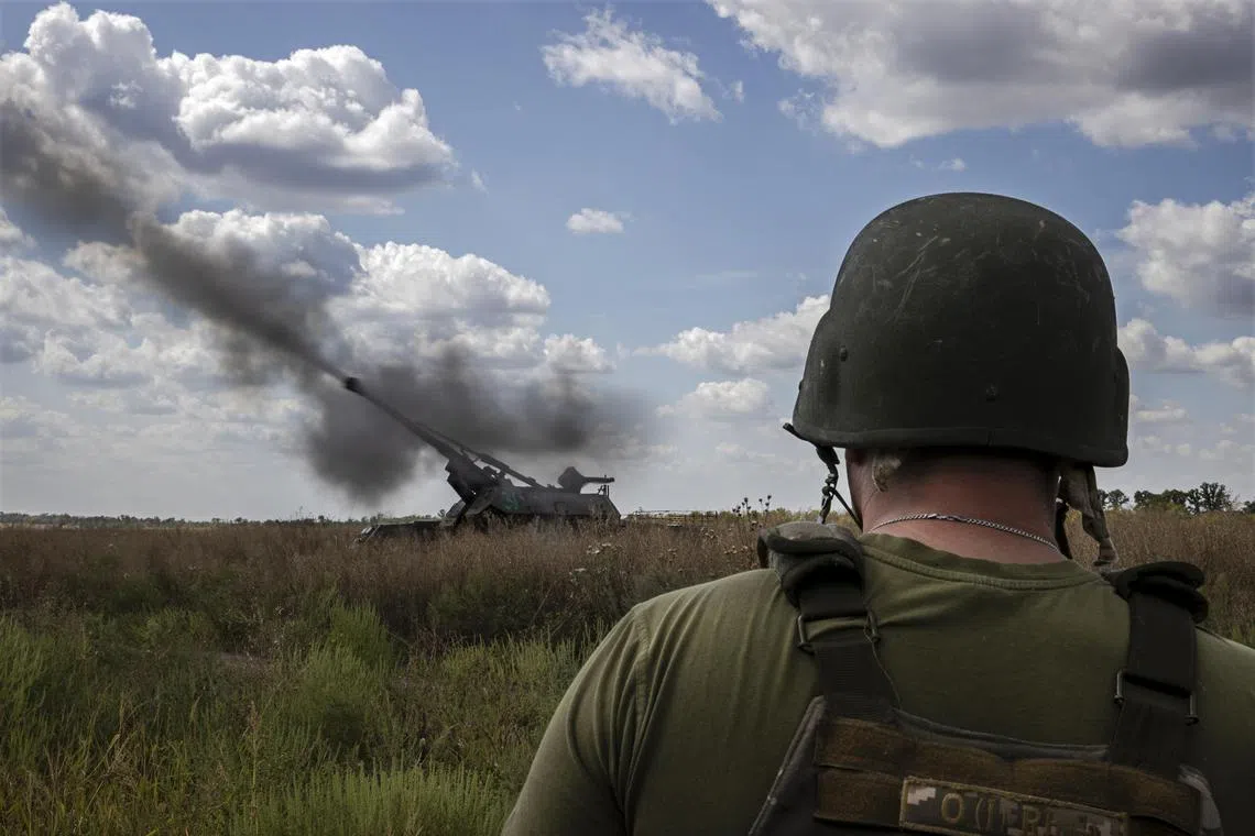 Ukrainian soldiers fire a self-propelled artillery gun at a Russian target in the Donetsk region of eastern Ukraine.