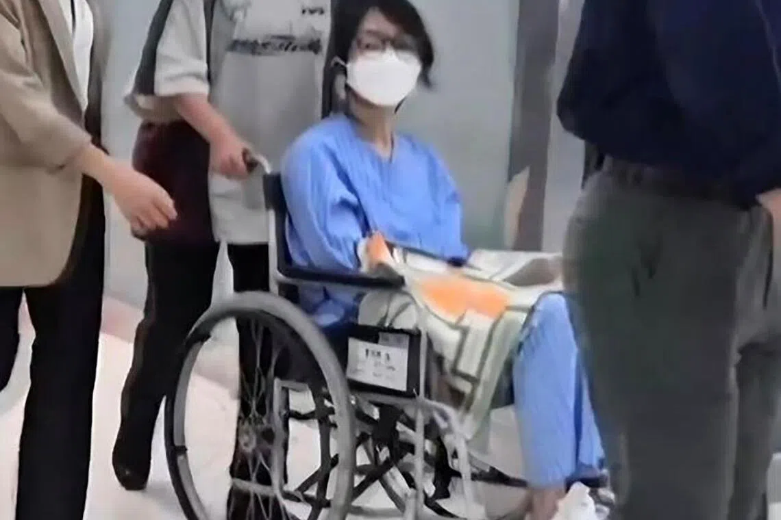 South Korea’s former first lady Kim Keon Hee was seen Sept 18 in the standard blue detainee uniform, wearing a mask and glasses, as she was escorted through hospital corridors.