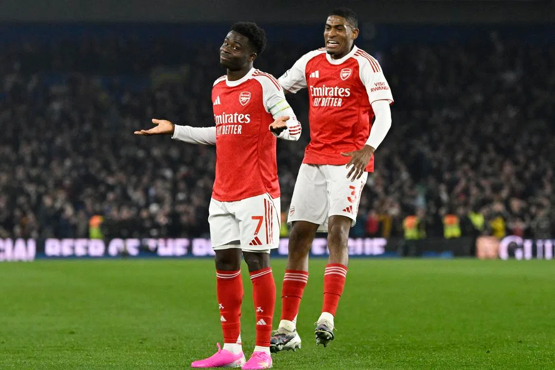 Soccer Football - Premier League - Brighton & Hove Albion v Arsenal - The American Express Community Stadium, Brighton, Britain - March 4, 2026 Arsenal's Bukayo Saka celebrates scoring their first goal with Cristhian Mosquera REUTERS/Tony O Brien