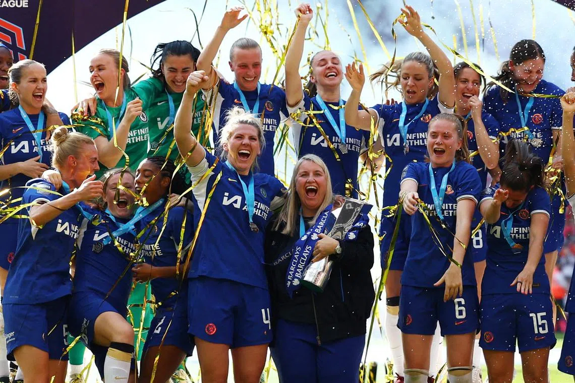 Manager Emma Hayes celebrates with the trophy, Millie Bright and her Chelsea players after winning the Women's Super League.    