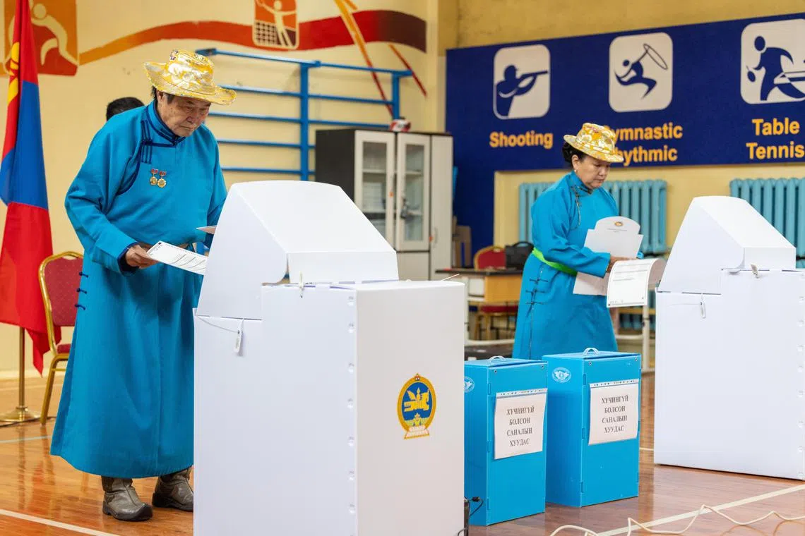 Voters cast their ballots during the Mongolian parliamentary elections at a polling station in Ulaanbaatar, Mongolia.