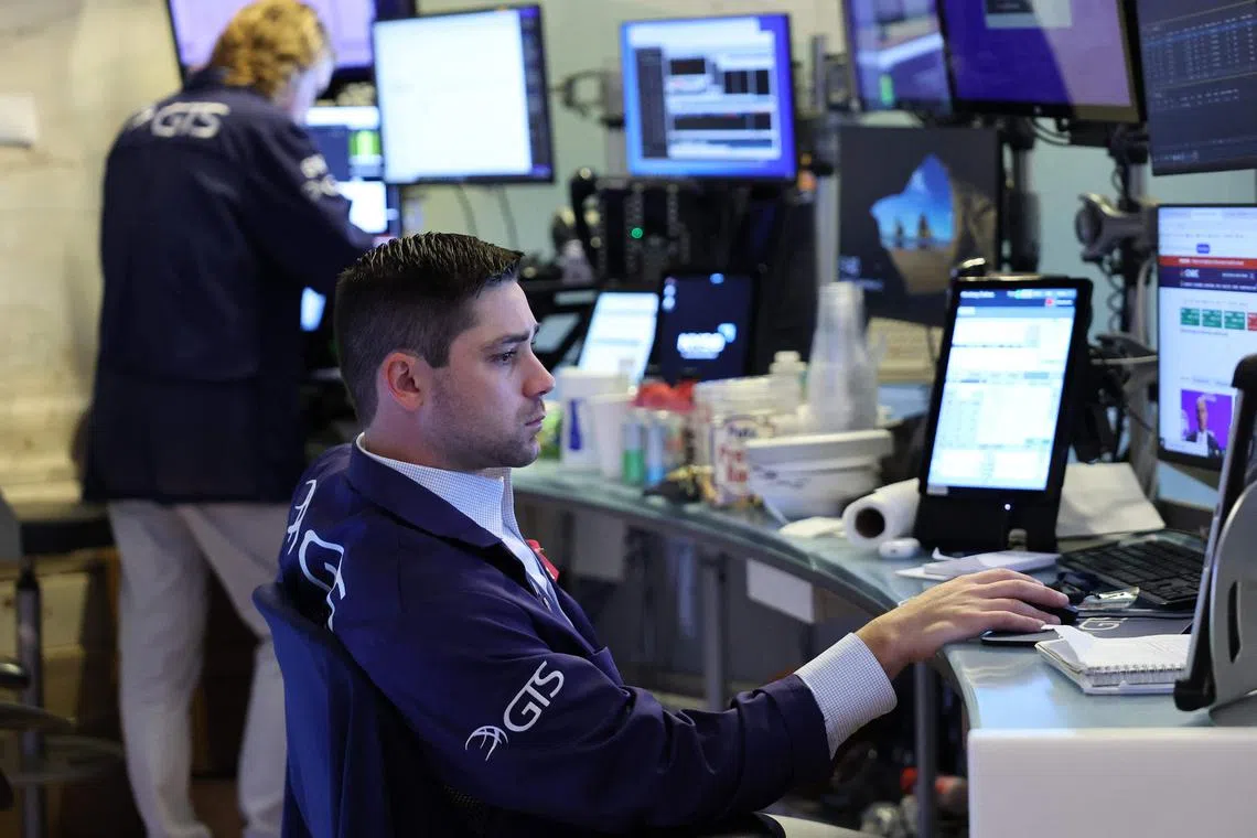 Traders work on the floor of the New York Stock Exchange, in New York City.