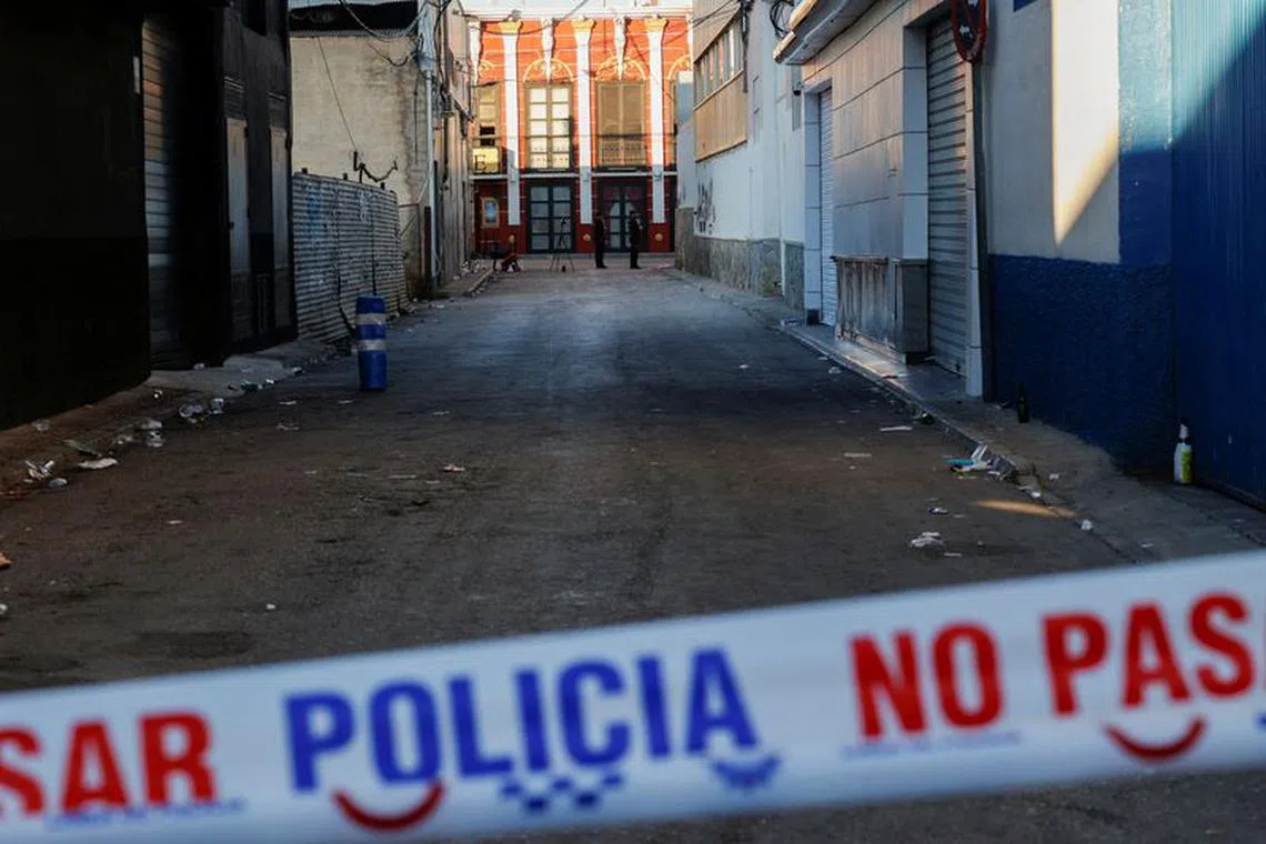 Policemen stand guard after adjoining nightclubs caught fire in Murcia, Spain, October 2, 2023. REUTERS/Eva Manez