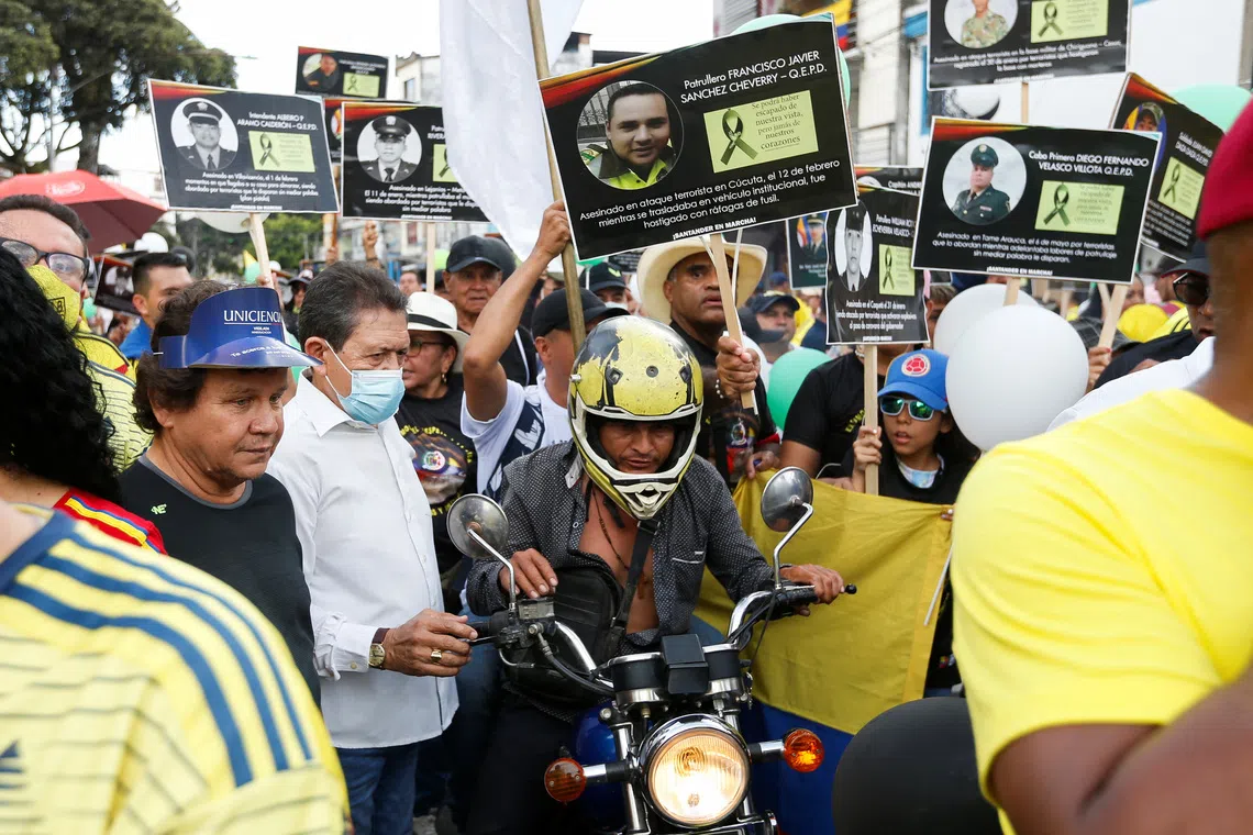 FILE PHOTO: People protest outside the Alfonso Lopez stadium before the Women's Copa America final match, against the killings of police officers by the Clan Del Golfo criminal gang, according to authorities, in Bucaramanga, Colombia July 30, 2022. REUTERS/Mariana Greif/File Photo