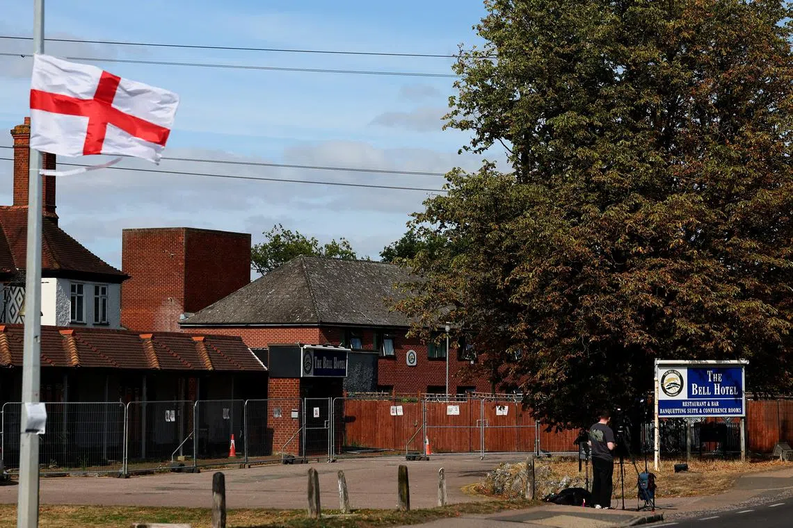 FILE PHOTO: Media reports outside The Bell Hotel, following Tuesday's High Court ruling in London that granted a temporary injunction to stop asylum seekers from being housed at the site, in Epping, Britain, August 20, 2025. REUTERS/Isabel Infantes/File Photo