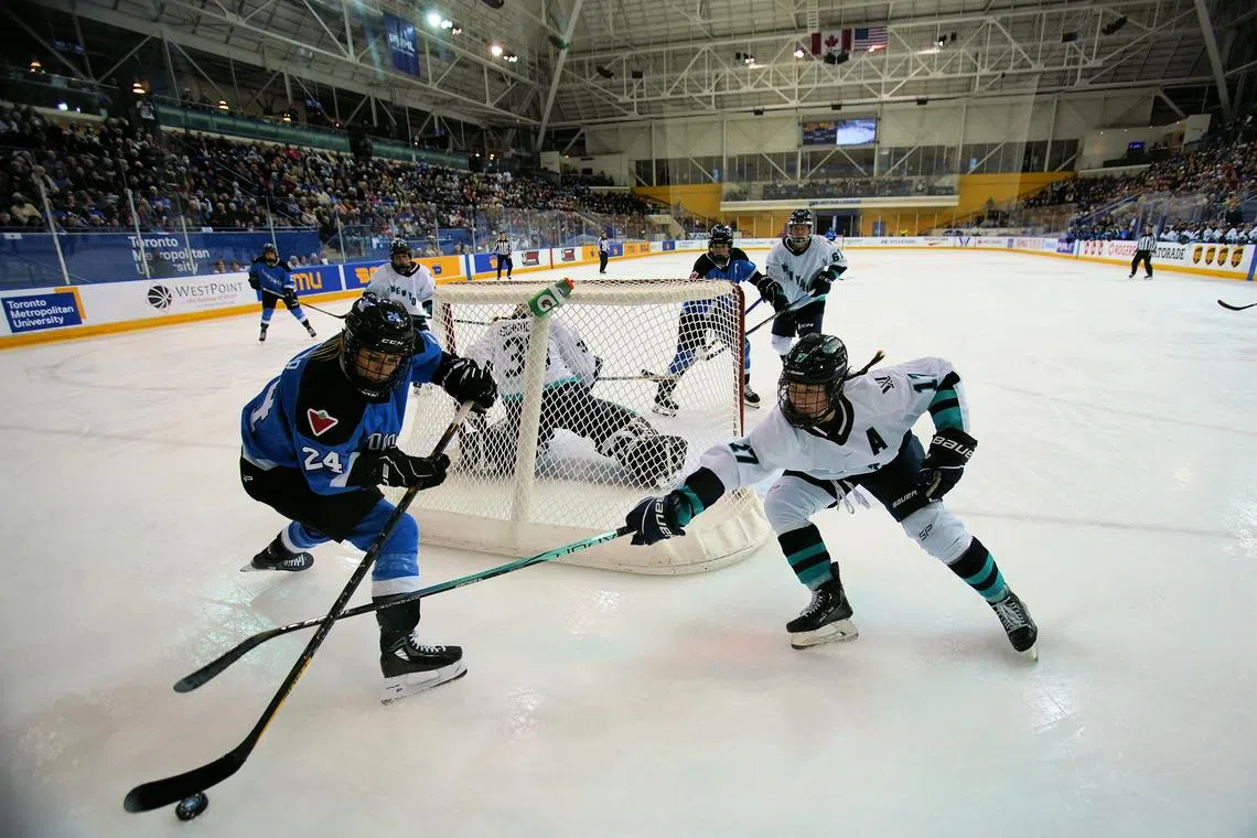 Jan 1, 2024; Toronto, Ontario, CANADA; New York defender Ella Shelton (17) tries to knock the puck away from Toronto forward Natalie Spooner (24) during the third period of the inaugural PWHL ice hockey game at Mattamy Athletic Centre. Mandatory Credit: John E. Sokolowski-USA TODAY Sports/File Photo