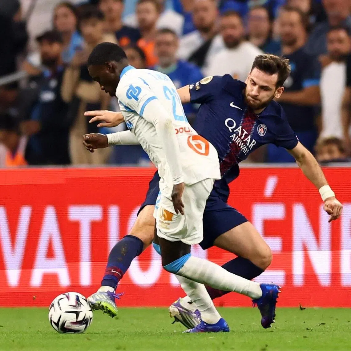 Marseille's Timothy Weah tussling for the ball with Paris St-Germain's Khvicha Kvaratskhelia in their French Ligue 1 match at Orange Velodrome in Marseille on Sept 22, 2025. 