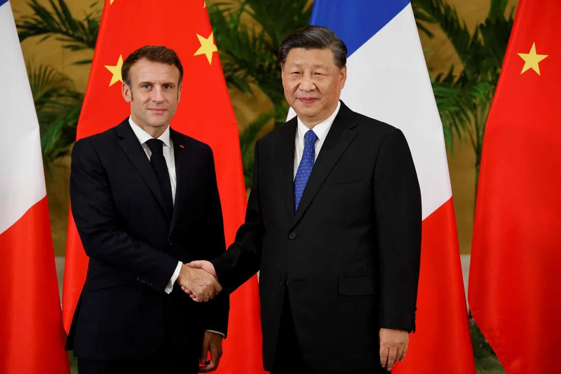 French President Emmanuel Macron (left) and Chinese President Xi Jinping meeting on the sidelines of the G-20 summit in Bali on Nov 15, 2022.