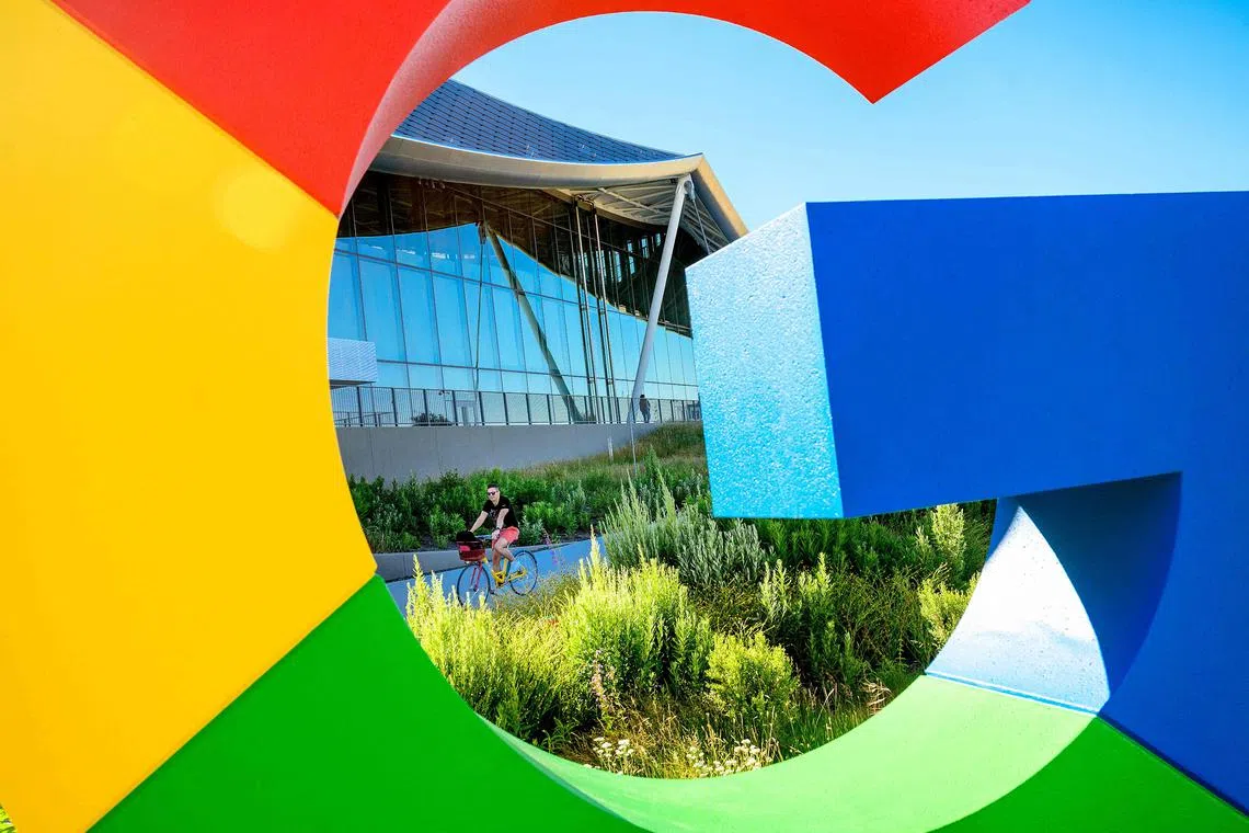 (FILES) In this file photo taken on June 27, 2022, a bicyclist rides along a path at Google’s Bay View campus in Mountain View, California. - Google on March 14, 2023, began letting some developers and businesses access the kind of artificial intelligence that has captured attention since the launch of Microsoft-backed ChatGPT last year. (Photo by NOAH BERGER / AFP)