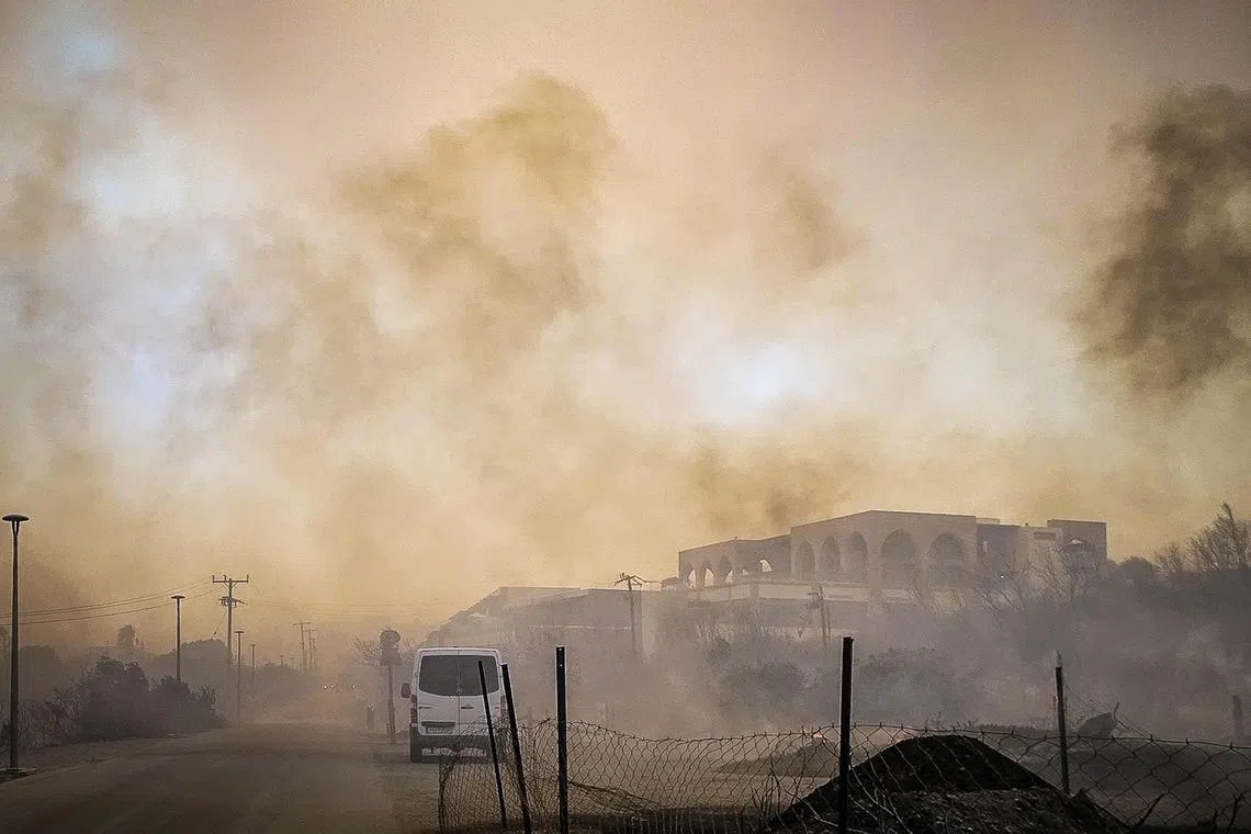 Smoke rises from a burnt hotel complex during a wildfire on the Greek island of Rhodes.