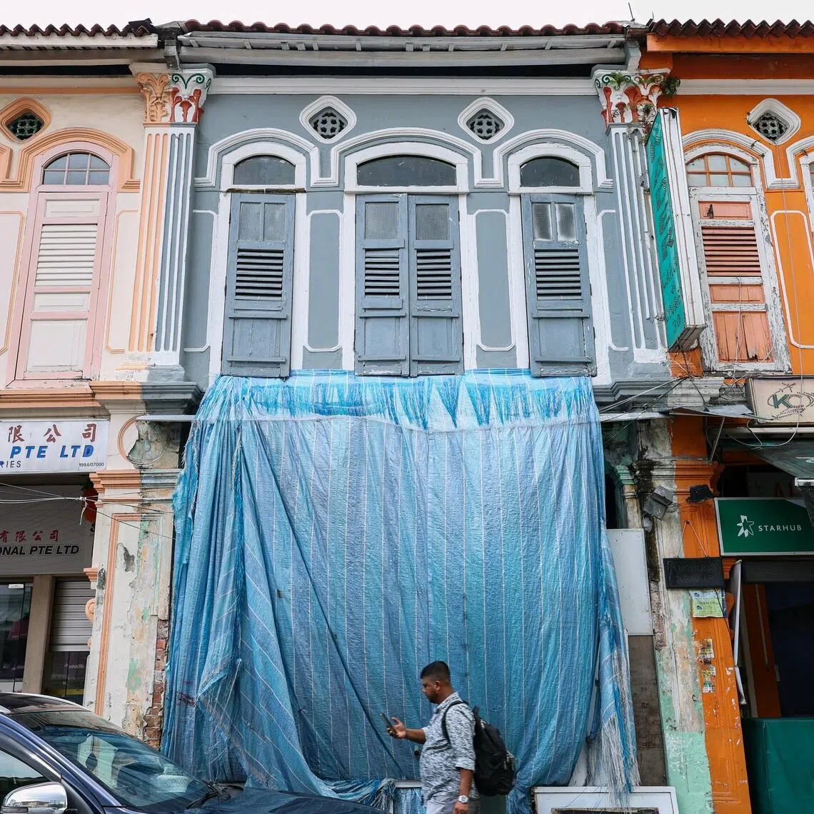 Manickam Nagarajan had purchased 32 Desker Road (grey facade), the two-storey shophouse in Little India, in October 2022.