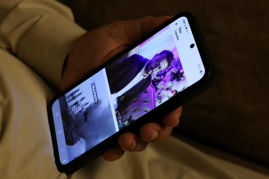 Ghulam Nabi Bahrani holds a mobile phone showing a picture of his son-in-law, Faisal Jatoi, who was the co-pilot (First Officer) of the K2 Airways Boeing 737 cargo plane that crashed in the Arabian Sea, at his home in Karachi, Pakistan, July 8, 2026. REUTERS/Akhtar Soomro
