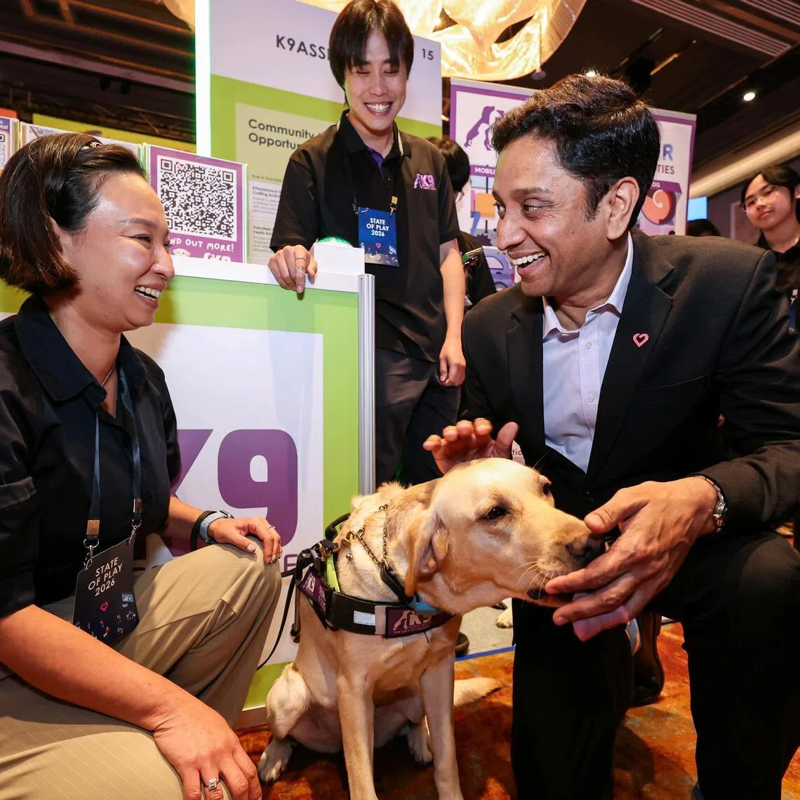 *EMBARGO UNTIL 3PM* Minister of State for Culture, Community and Youth and Manpower Dinesh Vasu Dash (right) petting an assistance dog while interacting with Ms Cassandra Chiu (left), 47, executive director of K9Assistance, while touring the State of Play exhibits at the City of Good Forum on March 31, 2026. ST PHOTO: BRIAN TEO