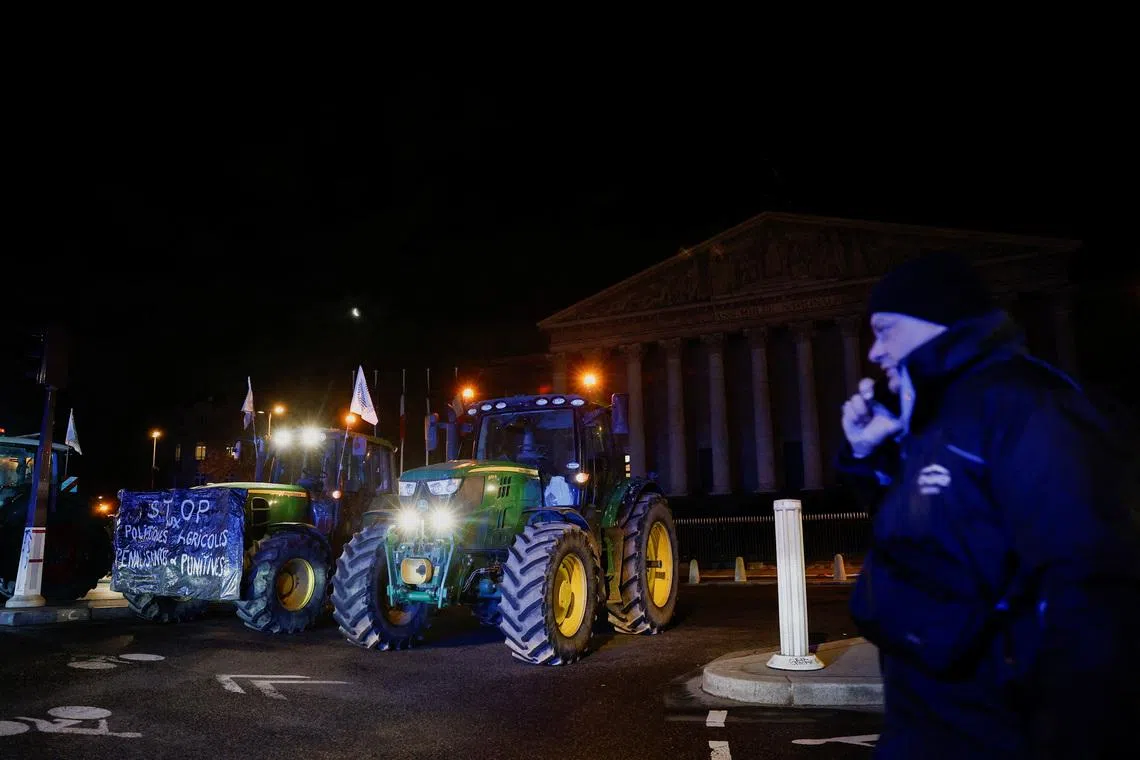 Tractors line up in front of the National Assembly as French farmers protest against the government's handling of the EU-Mercosur free trade agreement and lumpy skin disease outbreak, in Paris, France, January 13, 2026. REUTERS/Benoit Tessier