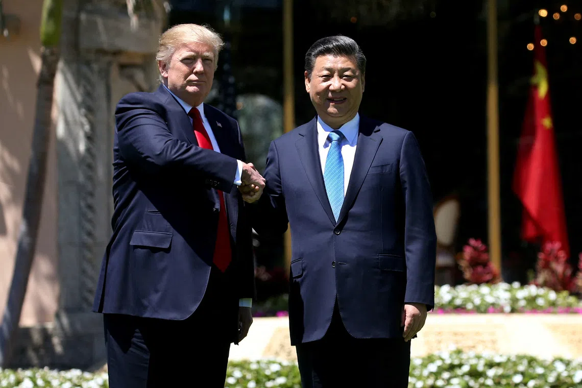 U.S. President Donald Trump (L) and China's President Xi Jinping shake hands while walking at Mar-a-Lago estate after a bilateral meeting in Palm Beach, Florida, U.S., April 7, 2017. REUTERS/Carlos Barria