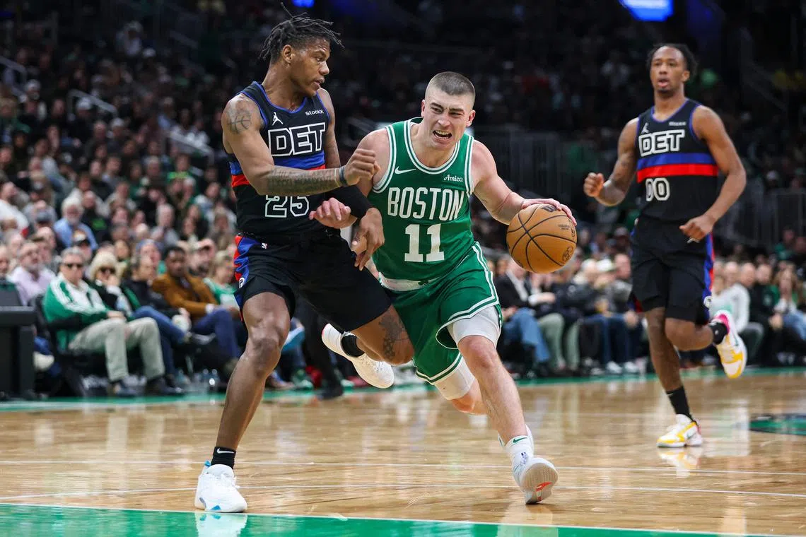 Payton Pritchard of the Boston Celtics goes to the basket while guarded by Marcus Sasser of the Detroit Pistons during the third quarter of a game at TD Garden.