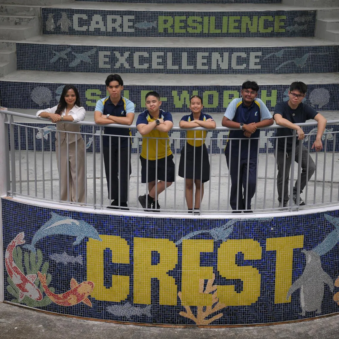 Crest Secondary School Alumnus Nur Saminah Sabtu (far left), 26 and Eric Liang (far right), 25, with current students, from left, Asher Cheow, 16, Willy Ng, 14, Ellefirah Ellyza Muhammad Firdaus, 16, and Muhammed Gaazi Basheer Ahmad, 15, pictured at the school's campus on Oct 12.