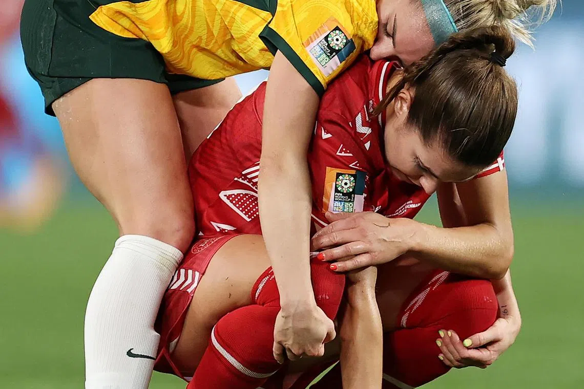 Ellie Carpenter of Australia consoles Signe Bruun of Denmark after their round of 16 match. 