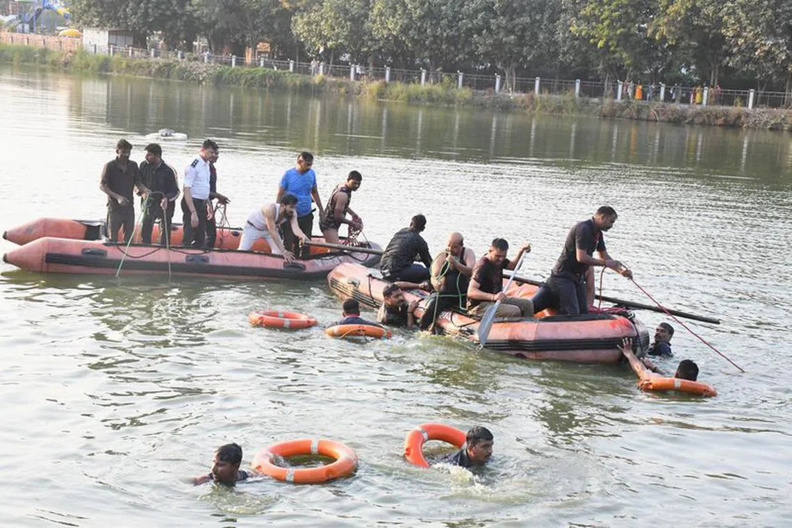Rescuers look for survivors in Harni lake where a boat carrying children and teachers who were on a picnic capsized in Vadodara, India, January 18, 2024. REUTERS/STRINGER