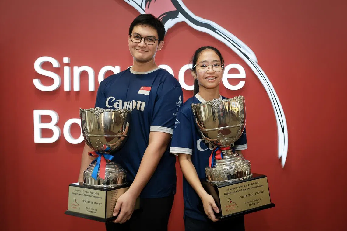 John Faragalla and Nur Irdina Hazly with their trophies after winning the 53rd Singapore National Bowling Championship open division men’s and women’s titles on Nov 25, 2023.