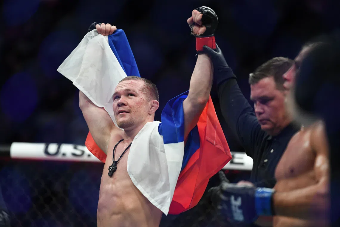 FILE PHOTO: Dec 14, 2019; Las Vegas, NV, USA; Petr Yan (red gloves) reacts after defeating Urijah Faber (blue gloves) during UFC 245 at T-Mobile Arena. Mandatory Credit: Stephen R. Sylvanie-USA TODAY Sports/File Photo
