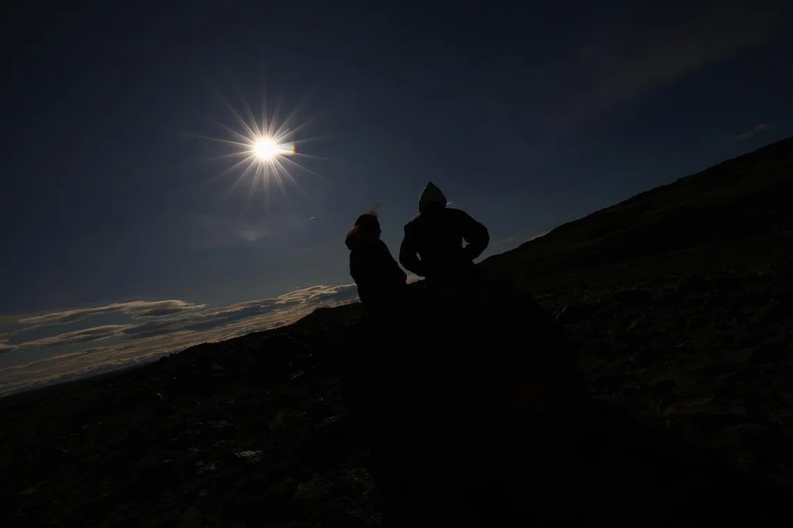 FILE PHOTO: People watch an annular solar eclipse in Las Horquetas, Santa Cruz, Argentina, October 2, 2024. REUTERS/Agustin Marcarian