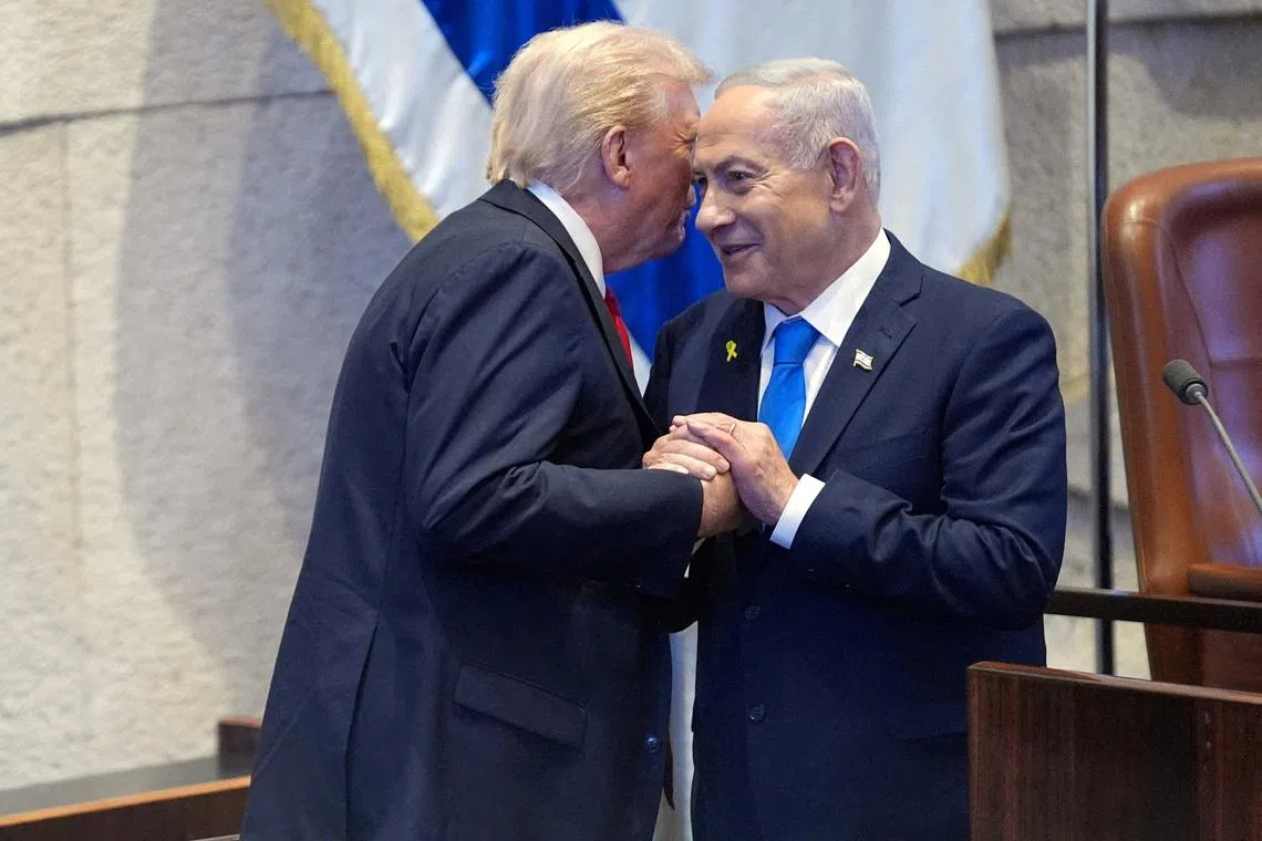 US President Donald Trump talks with Israel's Prime Minister Benjamin Netanyahu at the Knesset, in Oct 2025.