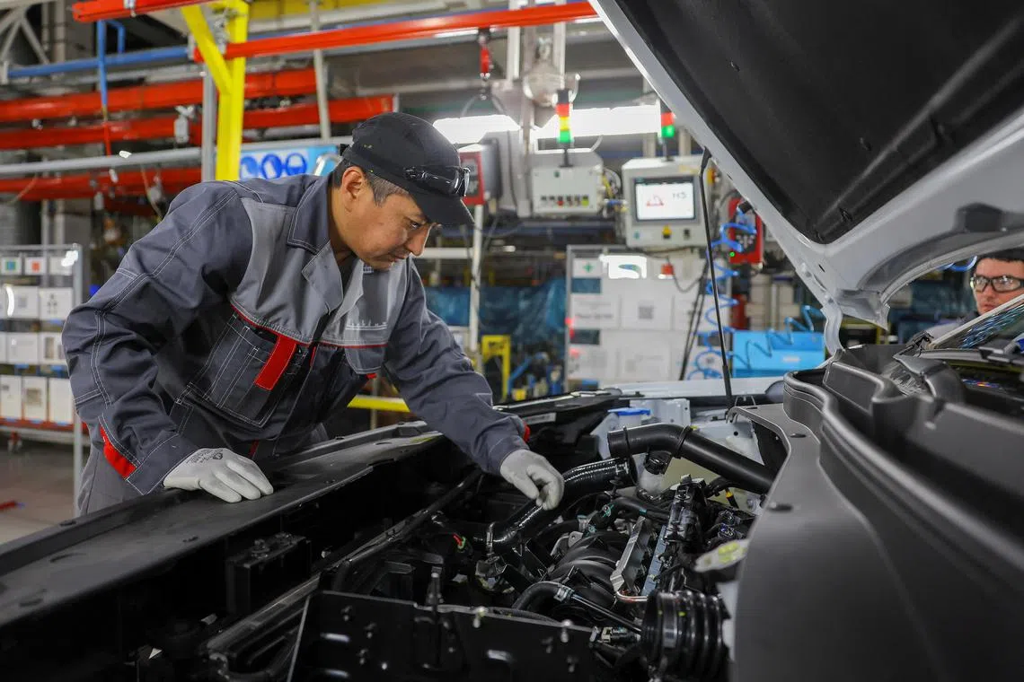 Employees work at the assembly line of the Moscow Automobile Factory Moskvich, after the production of cars under the Soviet-era brand Moskvich at French carmaker Renault's former plant was launched in Moscow, Russia, November 23, 2022.