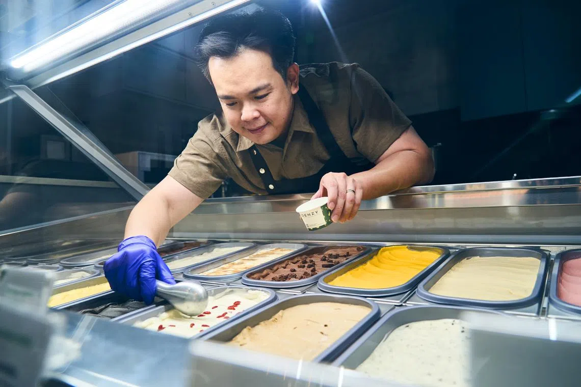 Owner of Denzy Damien Yau scooping a serving of Chrysanthemum Goji, part of its popular no-sugar-added range. 