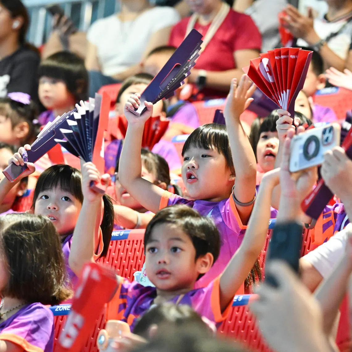 Little Team Nila volunteers cheering on swimming athletes at World Aquatics Championships Arena on Aug 1.