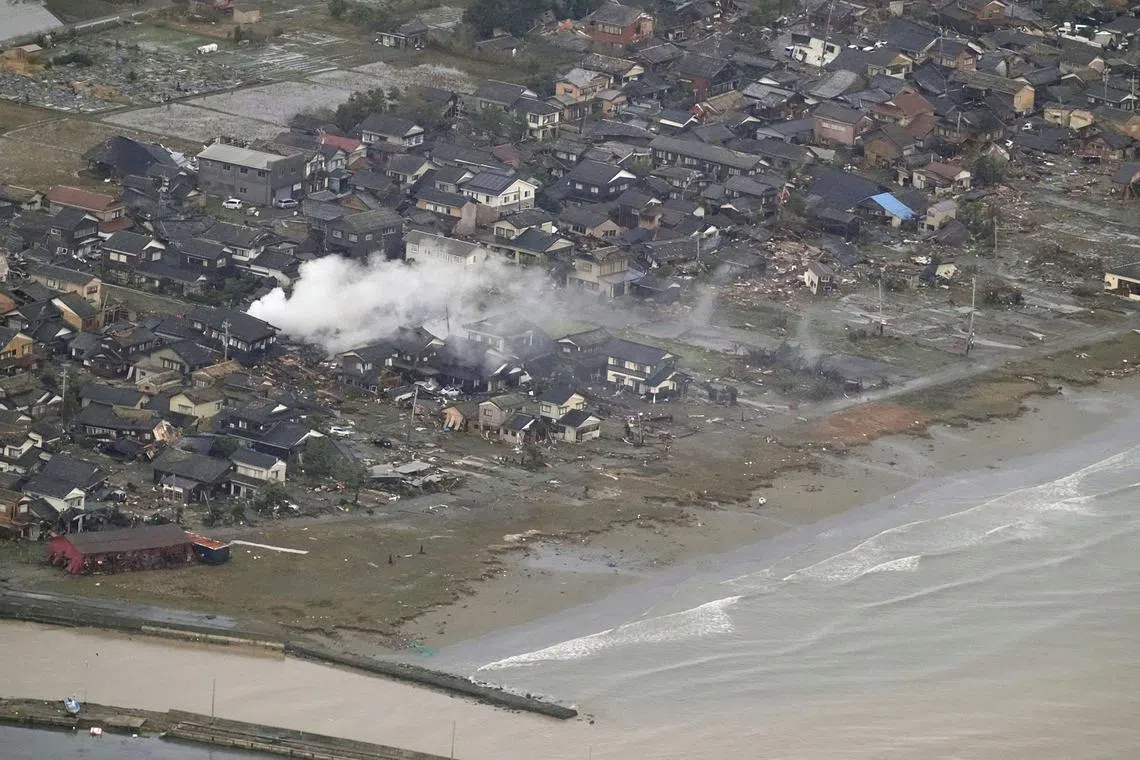 Smoke rises from the destroyed site caused by an earthquake at a residential area in Suzu, Ishikawa prefecture, Japan January 2, 2024, in this photo released by Kyodo. Mandatory credit Kyodo via REUTERS ATTENTION EDITORS - THIS IMAGE WAS PROVIDED BY A THIRD PARTY. MANDATORY CREDIT. JAPAN OUT. NO COMMERCIAL OR EDITORIAL SALES IN JAPAN