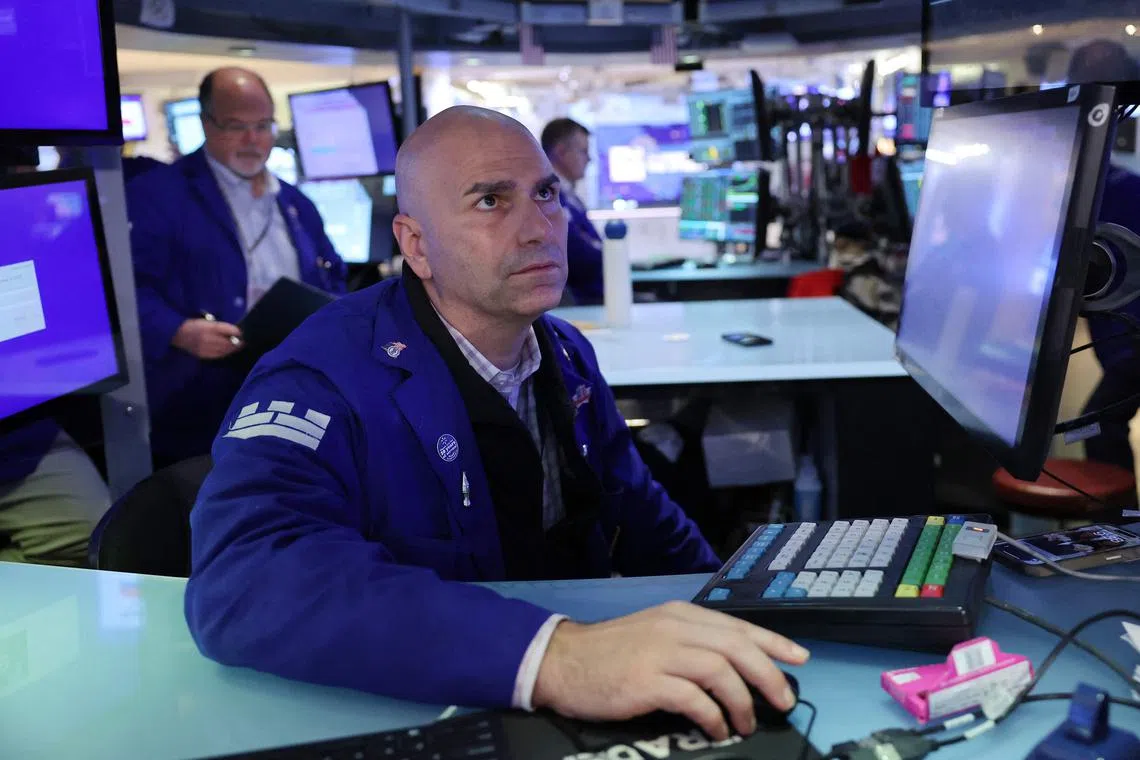 Traders work on the floor of the New York Stock Exchange, in New York City. 