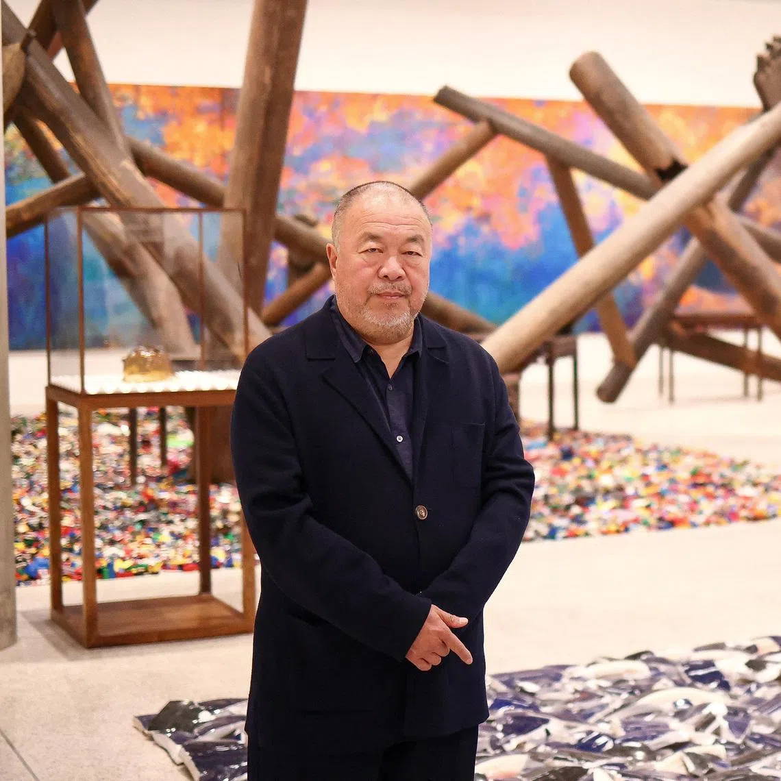 FILE PHOTO: Chinese artist Ai Weiwei poses during a photocall, amongst art pieces displayed in his exhibition \"Ai Weiwei: making sense\" at the Design Museum in London, Britain, April 4, 2023. REUTERS/Henry Nicholls/File Photo