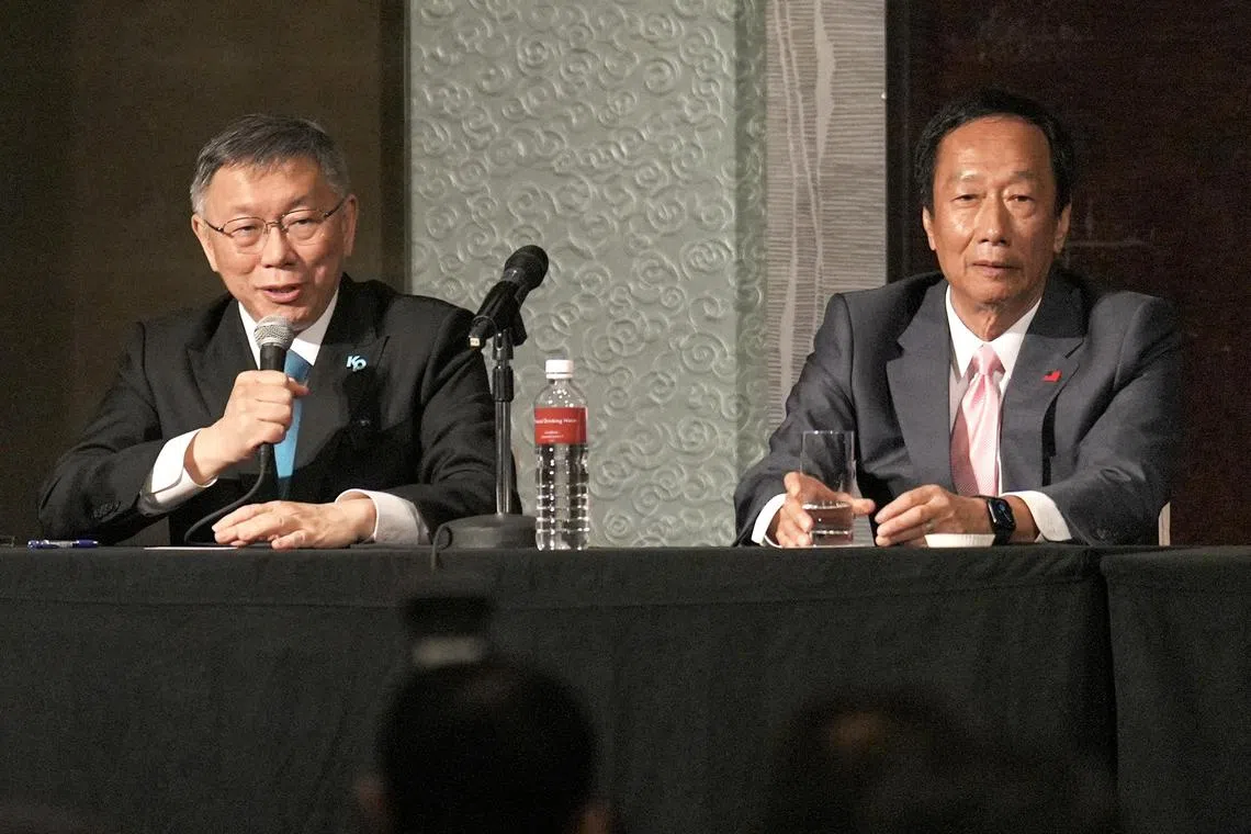 Taiwan People's Party chairman and presidential candidate Ko Wen-je (left) speaks beside Foxconn founder and presidential candidate Terry Gou, during a press conference in Taipei.
