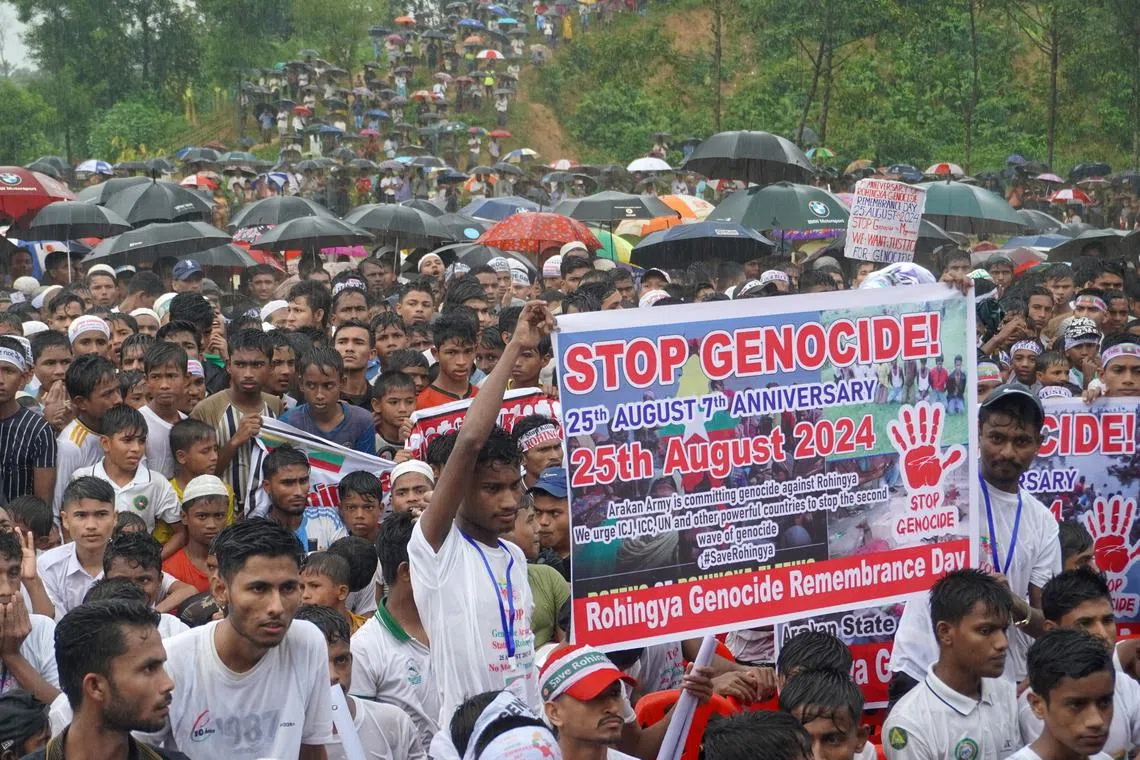 Rohingya refugees gather to mark the seventh anniversary of their fleeing from neighbouring Myanmar to escape a military crackdown in 2017, during heavy monsoon rains in Cox's Bazar, Bangladesh, August 25, 2024. REUTERS/Mokammel Mridha