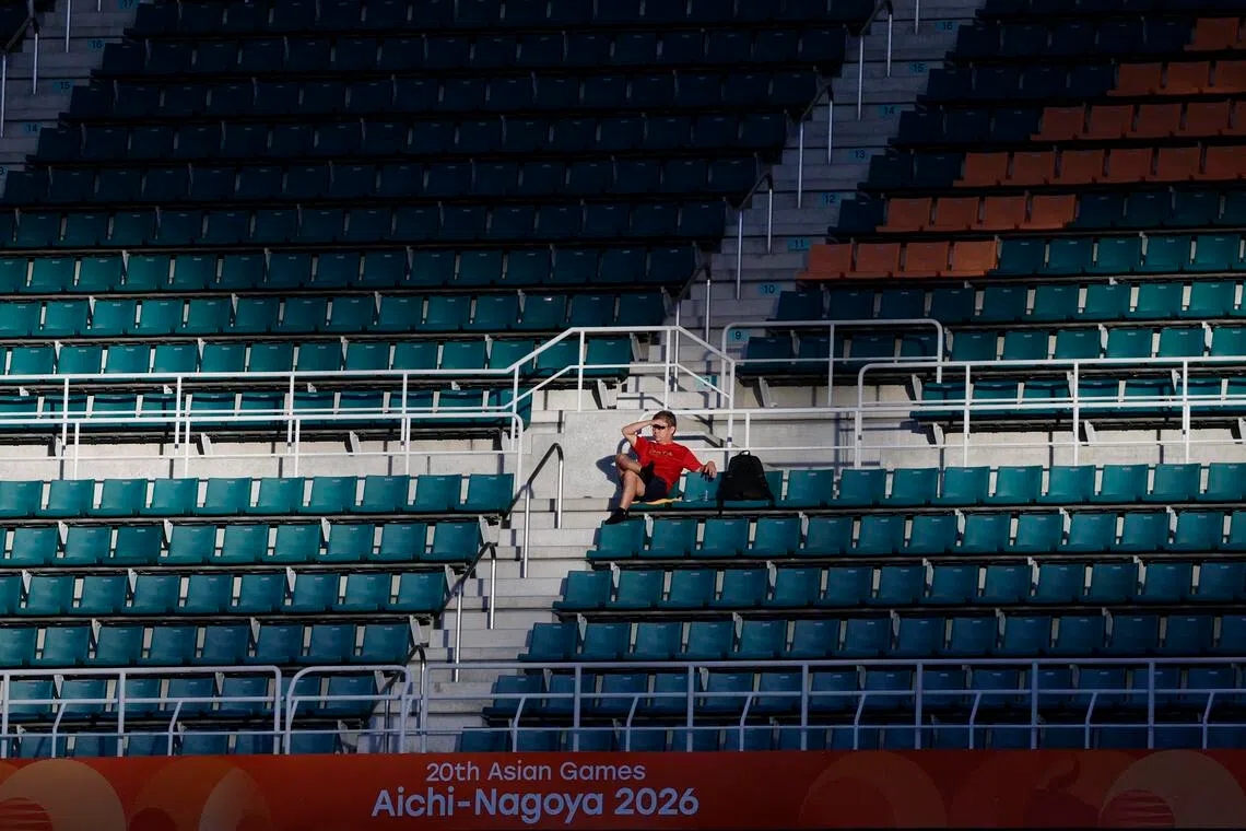 Asian Games - Aichi-Nagoya 2026 - Football - Group F - South Korea v North Korea - Shizuoka Stadium Ecopa, Fukuroi, Japan - September 21, 2026 General view as a fan sits amongst empty seats in the stands during the match REUTERS/Eloisa Lopez