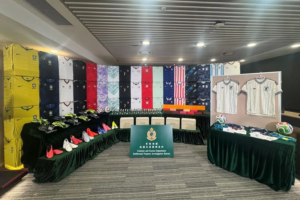 This handout photo released on June 11, 2026, by the Hong Kong Customs and Excise Department shows suspected counterfeit football jerseys and other goods related to World Cup teams seized by authorities in Hong Kong. Hong Kong officials said June 11 they had arrested six people in a World Cup fake merchandise sting involving almost 20 million USD of counterfeit goods. (Photo by Handout / Hong Kong Customs and Excise Department / AFP) / -----EDITORS NOTE --- RESTRICTED TO EDITORIAL USE - MANDATORY CREDIT "AFP PHOTO / Hong Kong Customs and Excise Department " - NO MARKETING - NO ADVERTISING CAMPAIGNS - DISTRIBUTED AS A SERVICE TO CLIENTS