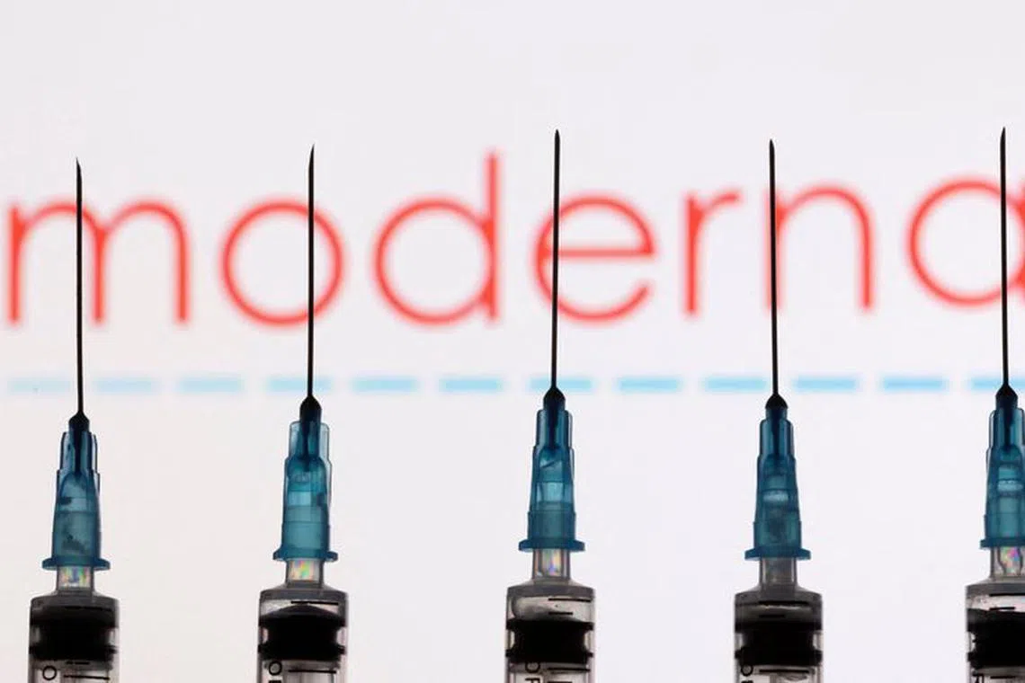 FILE PHOTO: Syringes with needles are seen in front of a displayed Moderna logo in this illustration taken, November 27, 2021. REUTERS/Dado Ruvic/Illustration/File Photo