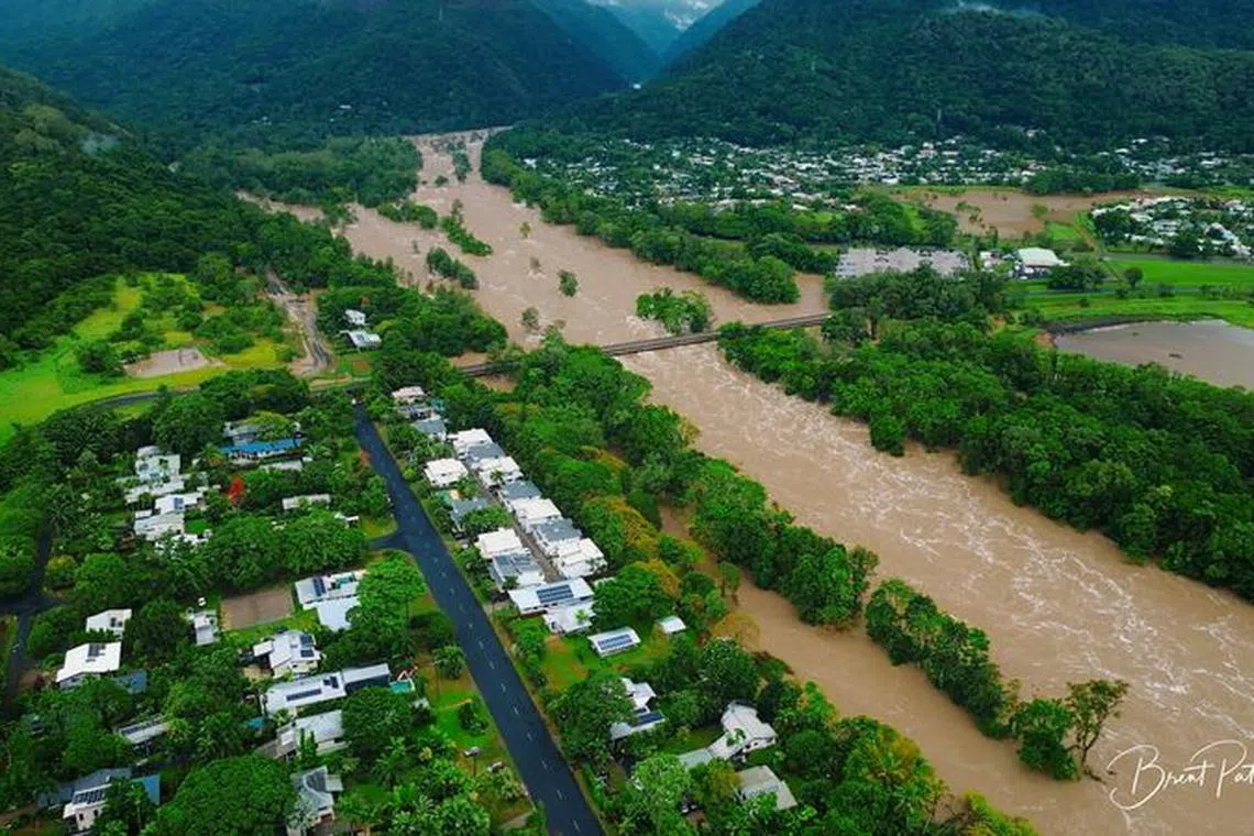 An aerial view shows flooding caused by heavy rains and water gushing through the Barron River, in Cairns, Queensland, Australia December 18, 2023 in this screen grab obtained from social media video. Brent Paterson/via REUTERS