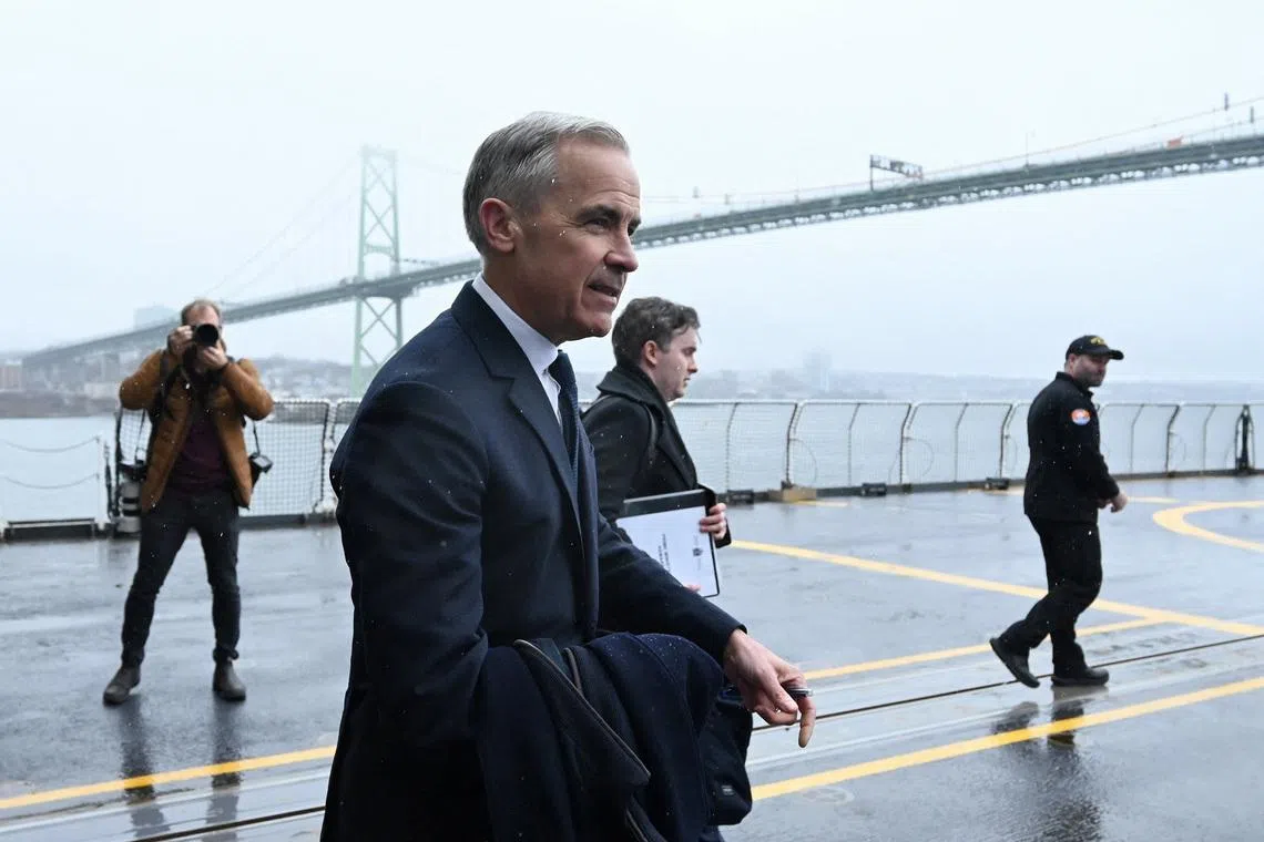 Canada's Prime Minister Mark Carney walks on the flight deck of HMCS Margaret Brooke at HMC Dockyard in Halifax, Nova Scotia, Canada March 26, 2026.  REUTERS/Ingrid Bulmer
