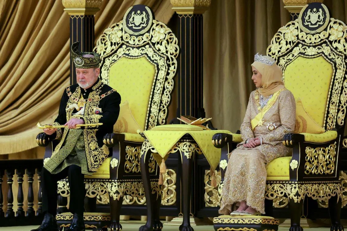 The seventeenth King of Malaysia, Sultan Ibrahim Sultan Iskandar, lifts a ceremonial dagger during his coronation at the National Palace in Kuala Lumpur on July 20, 2024. (Photo by HASNOOR HUSSAIN / POOL / AFP)