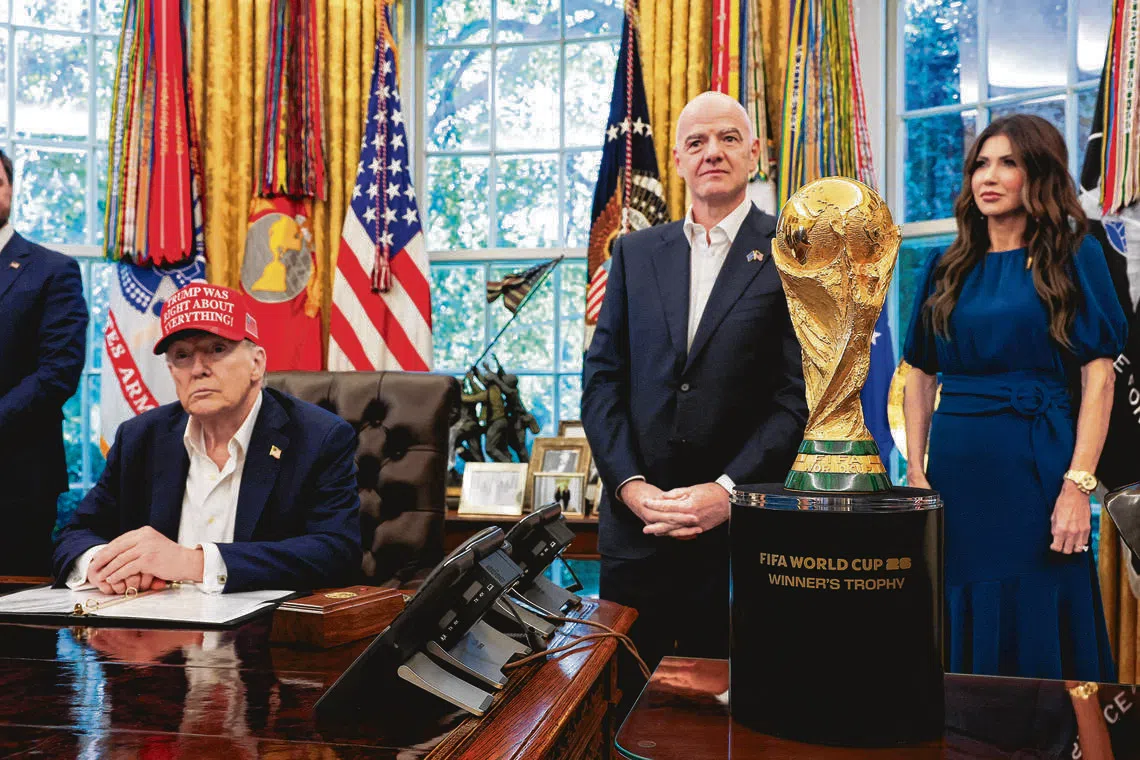 (From left) U.S. President Donald Trump sits near the FIFA World Cup Trophy, as FIFA president Gianni Infantino and U.S. Homeland Security Secretary Kristi Noem stand, in the Oval Office at the White House on Aug 22, 2025.