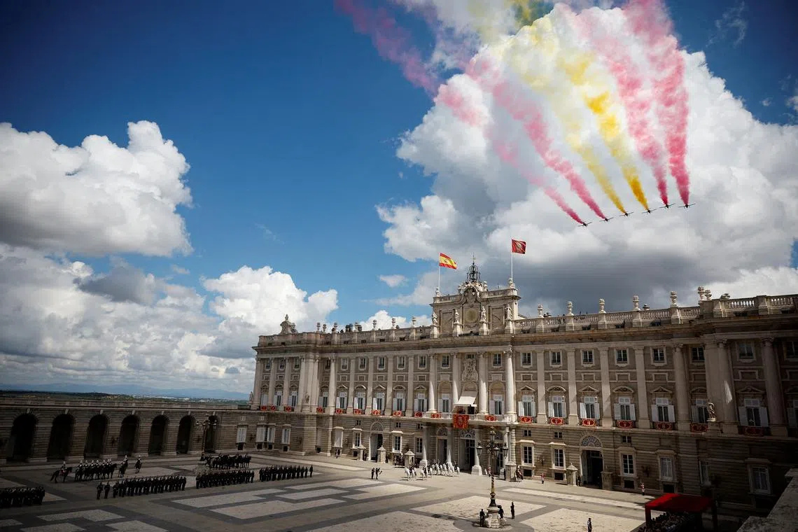 The aerobatic team "Patrulla Aguila" (Eagle Patrol) of the Spanish Air and Space Force flying past the Royal Palace during celebrations, marking the 10th anniversary of the proclamation of Spain's King Felipe VI, in Madrid, Spain, on June 19, 2024. 