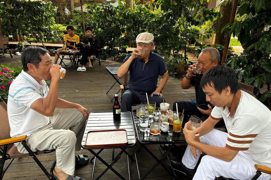 Aeroco’s owner Le Dinh Tu drinking coffee with visitors at the cafe on his farm near Ea Kao Lake in Buon Ma Thuot, Vietnam’s coffee capital in Dak Lak province, on June 30.