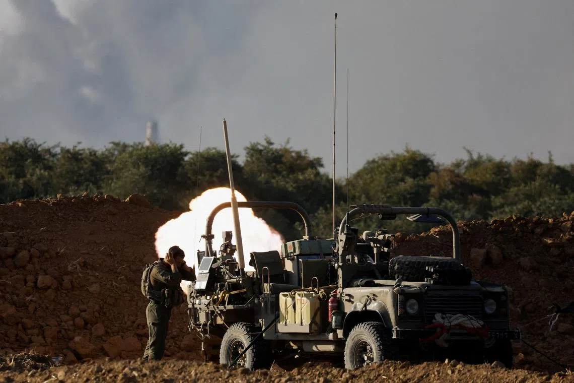 FILE PHOTO: An Israeli soldier fires a mortar, amid the Israel-Hamas conflict, near the Israel-Gaza border, in Israel, July 9, 2024. REUTERS/Amir Cohen/File Photo