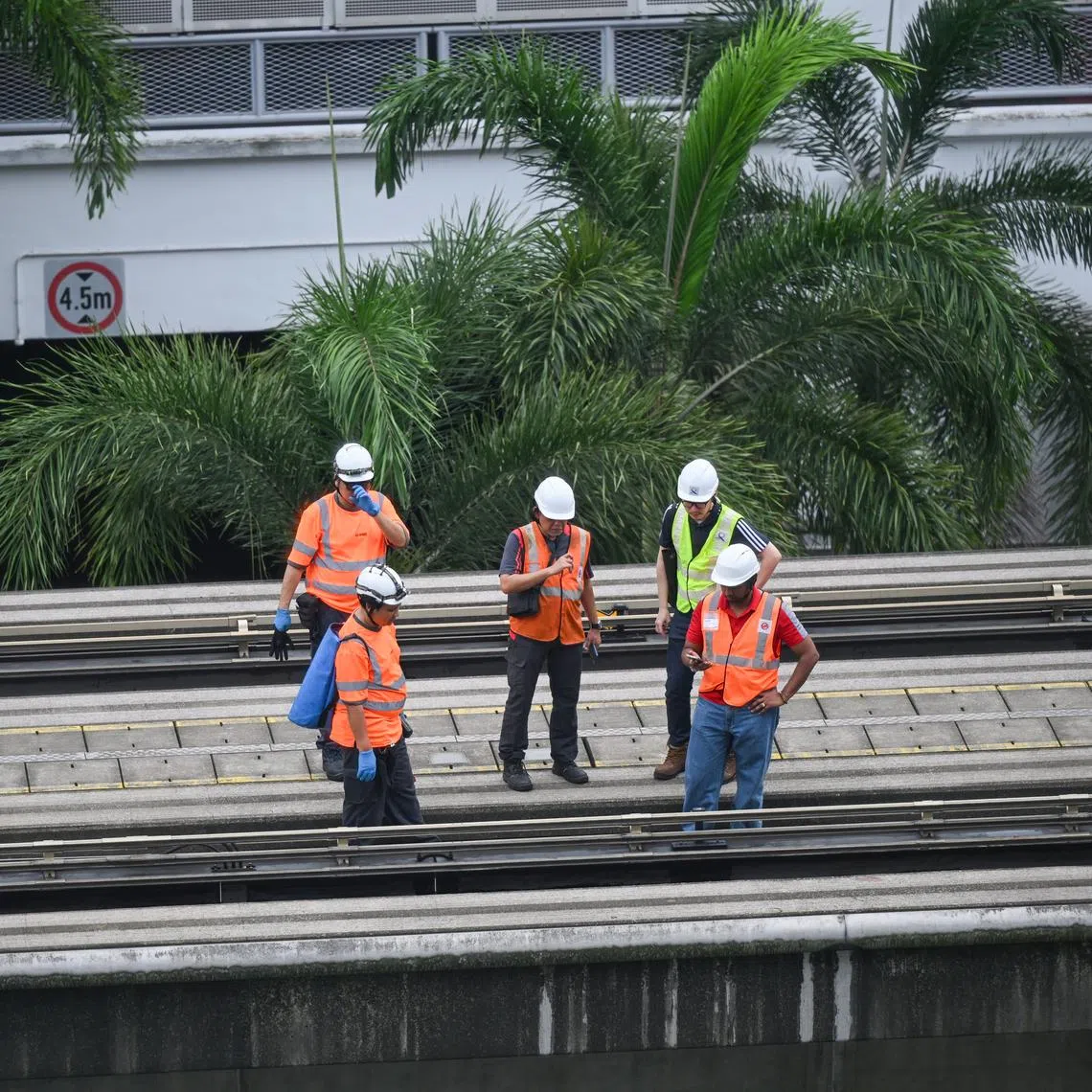 Staff inspecting the train tracks at Segar LRT station on May 18, after a man fell onto the tracks and died.