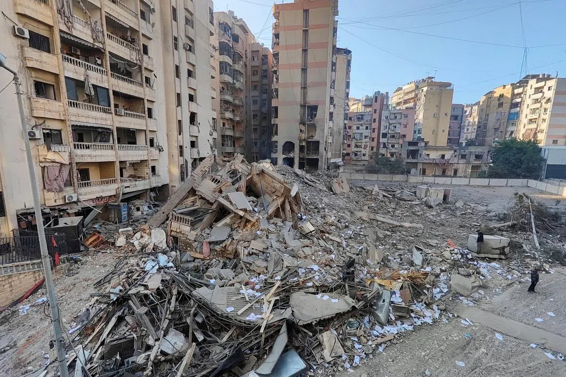 People stand at a site damaged in the aftermath of Israeli strikes on Beirut's southern suburbs, amid the ongoing hostilities between Hezbollah and Israeli forces, Lebanon, November 1, 2024. REUTERS/Mohammed Yassin