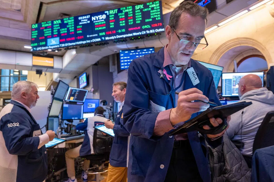 Traders work on the floor of the New York Stock Exchange, in New York City.