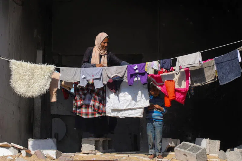 Palestinians shelter in a building of the Islamic University, amid a ceasefire between Israel and Hamas, in Gaza City, on Oct 16.